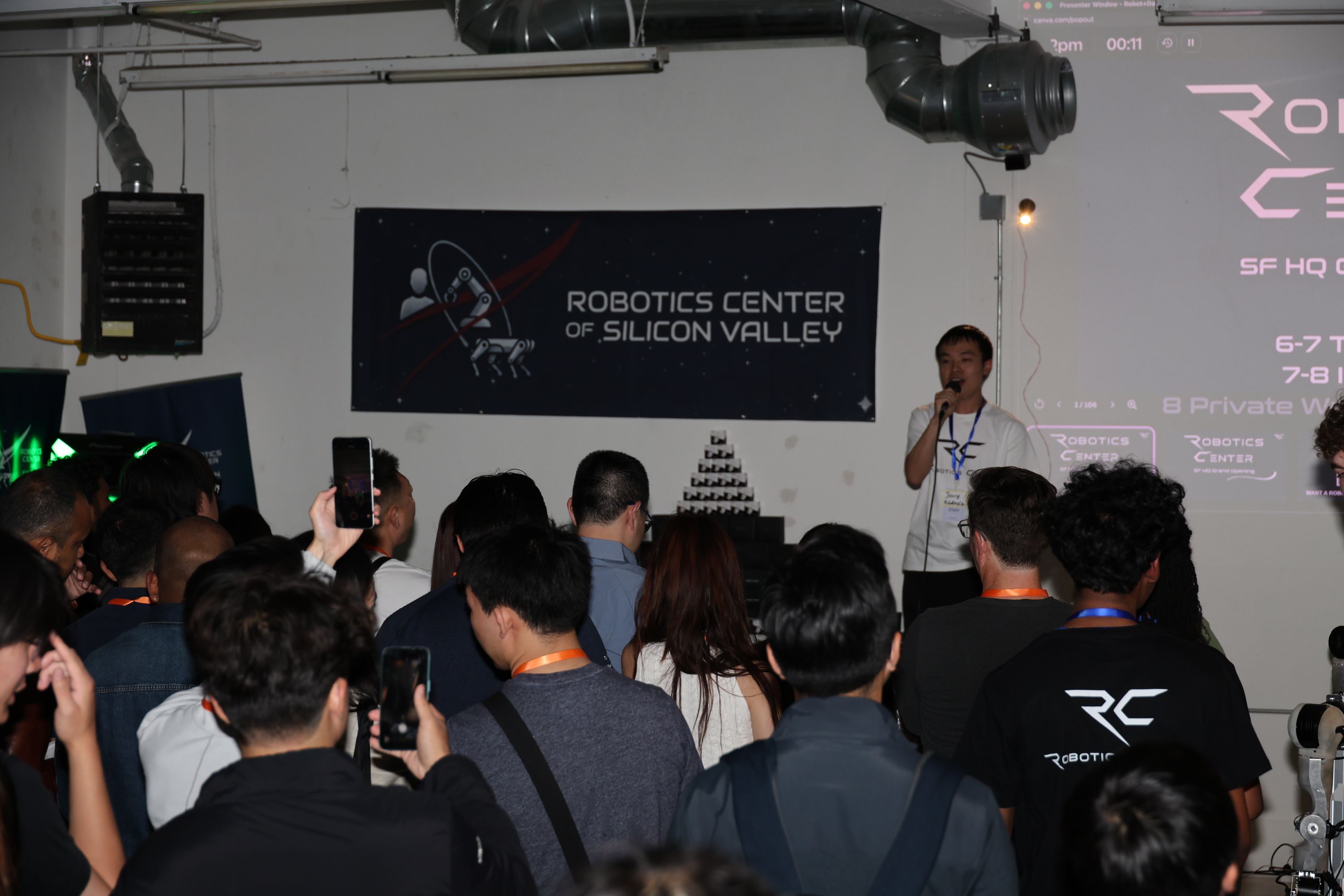 Audience listening to a presentation beneath the Robotics Center of Silicon Valley banner